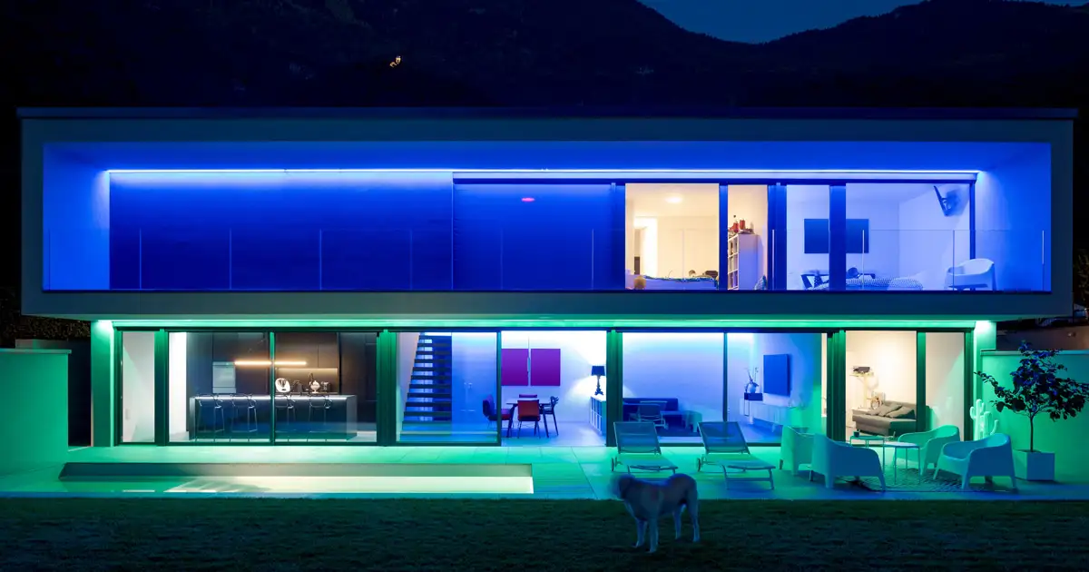 Modern home with RGB permanent lighting system showcasing color changing exterior lighting design