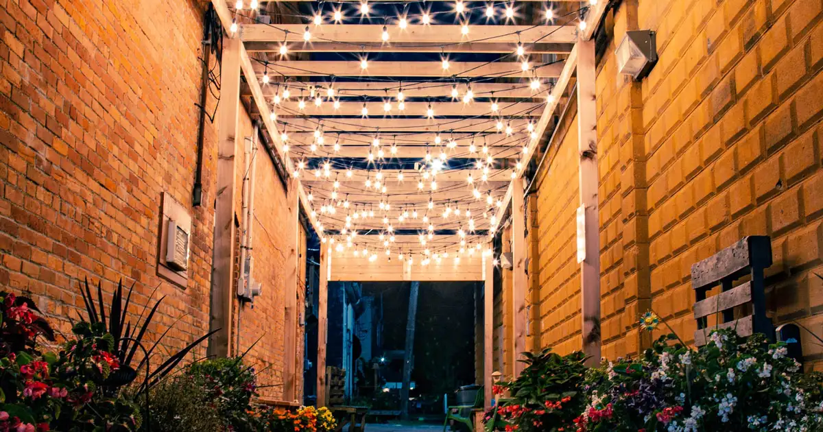 Elegant outdoor table setup with string lights creating a romantic and intimate dining atmosphere