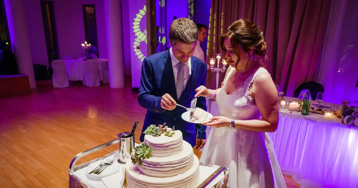Ceiling draped string lights creating luxurious indoor wedding lighting design