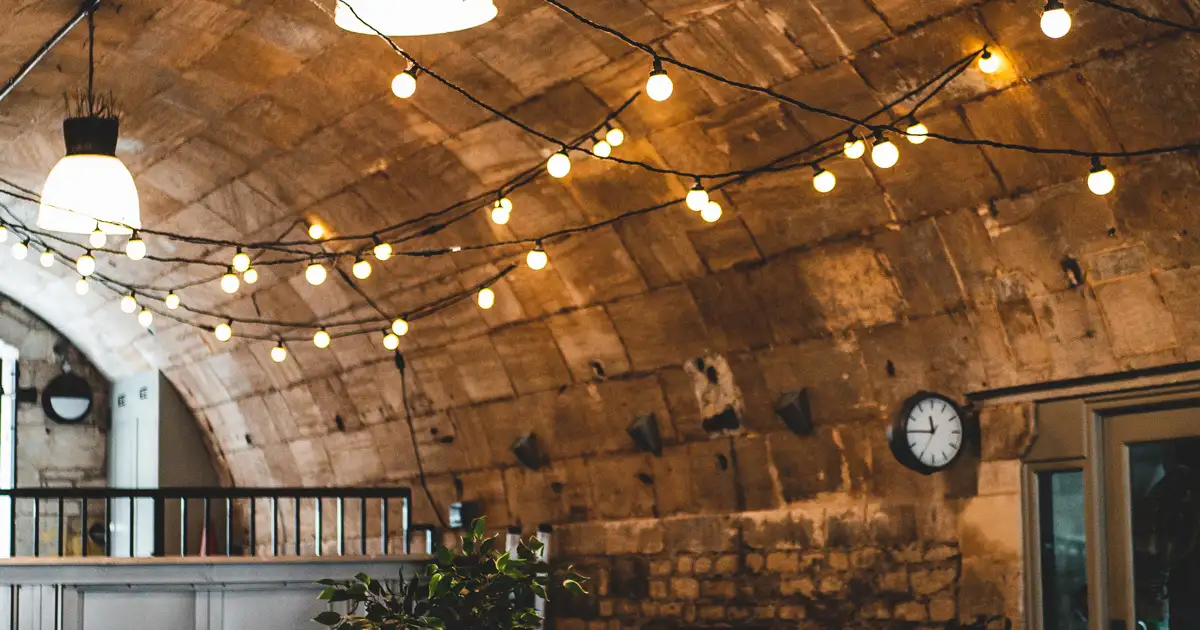Indoor cafe with decorative string lights creating warm and inviting lighting atmosphere