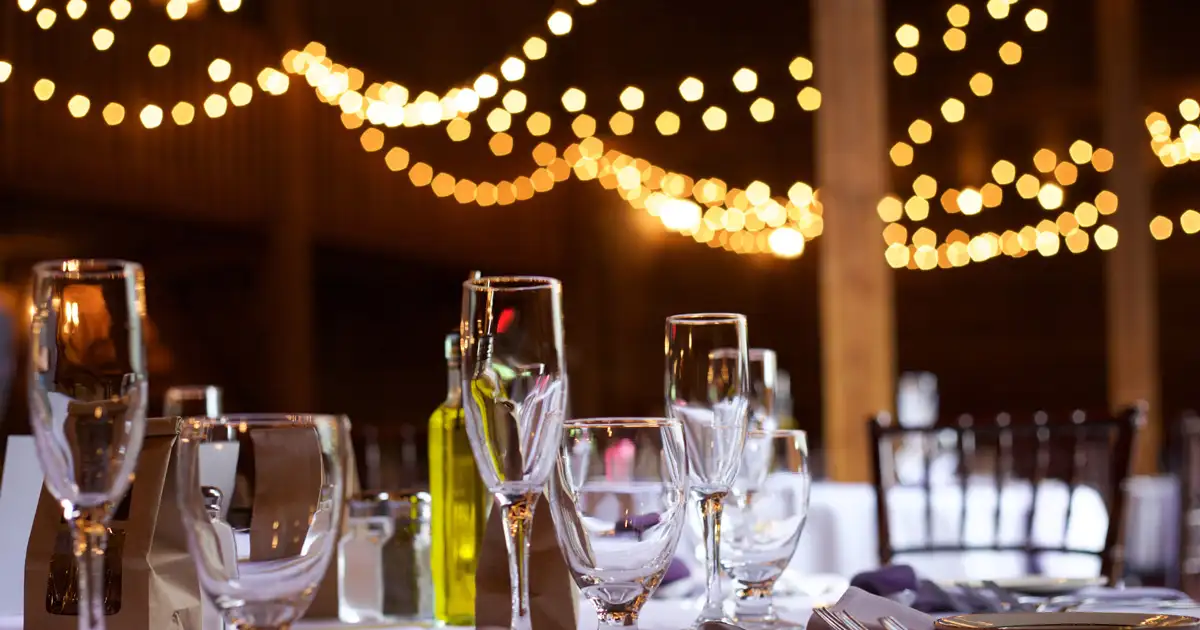 Restaurant outdoor seating area with overhead string lights enhancing dining ambiance